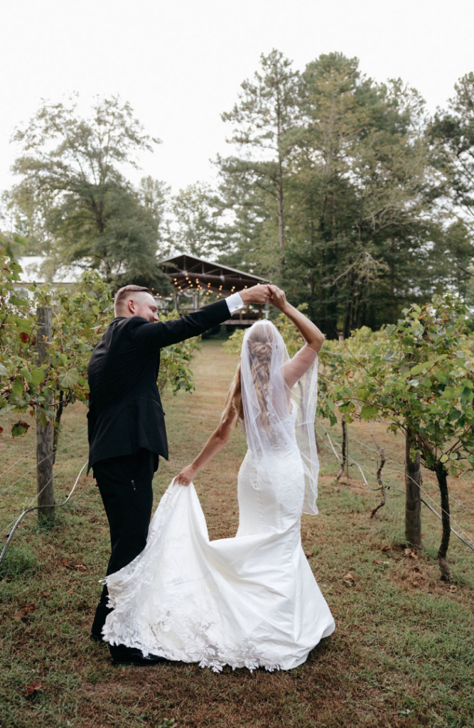 Bride and groom dancing in the vineyards at Koury Farms